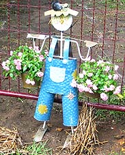 A miniature garden scarecrow